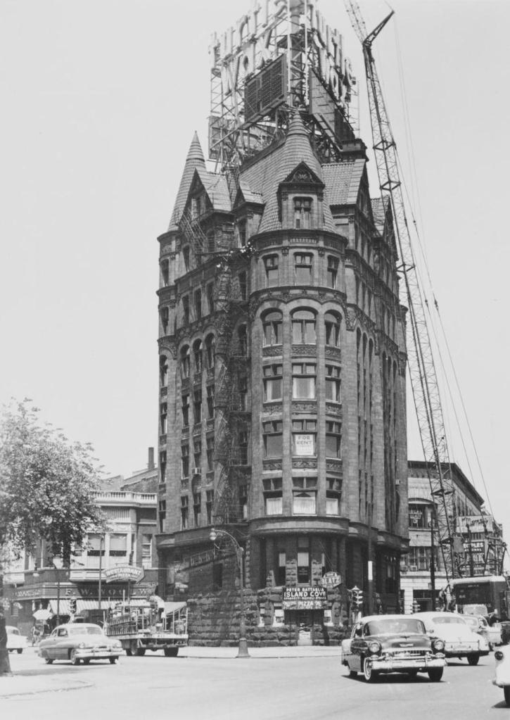 The building in 1956 when Tommy was being mounted on top (left) and the intersection as it looked in 2021 (right) (Chicago Architectural Photographing Company, Neil Arsenty)